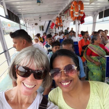 Act1-Act2-Intermission-female-guide-and-tourist-smiling-inside-a-passenger-ferry-crossing-the-hooghly-river-in-kolkata
