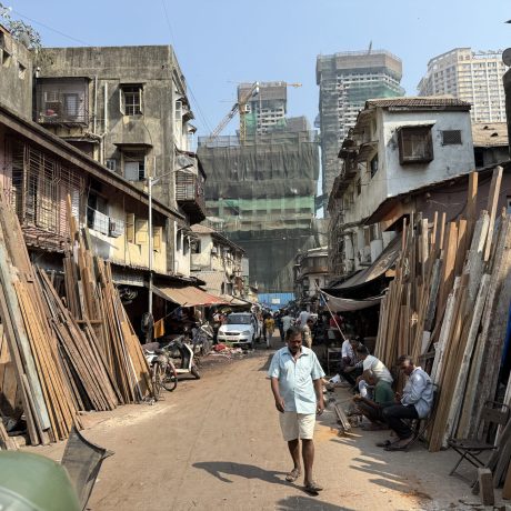 H3 Act 3 Pic 2- narrow-woodworking-and-timber-alley-in-chor-bazaar-with-modern-skyscrapers-in-the-background-during-the-mumbai-full-day-tour